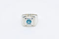 Silver ring with a blue gemstone on a white background